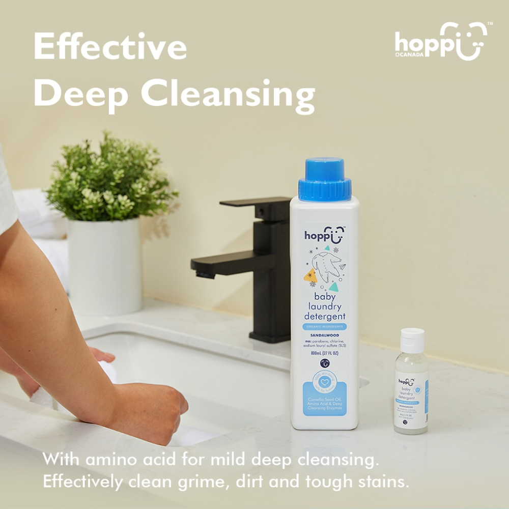 Astra Family A woman is using the 800ml Hoppi Baby Laundry Detergent to wash her hands in a bathroom.