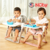 Astra Family Two children sitting in a foldable Nuby Booster Seat eating food.